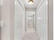 Hallway featuring carpet flooring and white closet doors with hardware at 10460 Silver Maple Ave, Oxford, FL 34484