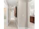 Hallway with decorative accents leading to a bathroom and kitchen area at 10460 Silver Maple Ave, Oxford, FL 34484