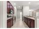 Well-equipped kitchen with stainless appliances and dark brown cabinetry at 10460 Silver Maple Ave, Oxford, FL 34484