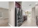 Bright open kitchen with stainless steel refrigerator, granite countertops, and tile flooring at 10460 Silver Maple Ave, Oxford, FL 34484