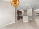 Open concept kitchen with stainless steel appliances, dark wood cabinets, and breakfast bar at 10460 Silver Maple Ave, Oxford, FL 34484