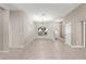 Bright, open living area with tile flooring and a view of the front yard, enhanced by natural light at 10460 Silver Maple Ave, Oxford, FL 34484