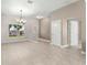 Spacious living area with tile floors and an elegant chandelier, creating a warm, inviting atmosphere at 10460 Silver Maple Ave, Oxford, FL 34484