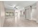 Spacious living room with tile flooring, ceiling fan, and natural light at 10460 Silver Maple Ave, Oxford, FL 34484