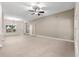 Bright living room with neutral paint, chandelier, and tile flooring at 10460 Silver Maple Ave, Oxford, FL 34484