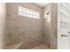 Modern shower with tiled walls, built-in seat, and glass block window at 10460 Silver Maple Ave, Oxford, FL 34484