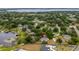 Aerial view of the property, revealing its location among lush trees and serene lake access at 11024 Windchime Cir, Clermont, FL 34711