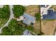 Aerial shot of property showcasing the home's roof, sprawling lot, and nearby landscaping and trampoline at 11024 Windchime Cir, Clermont, FL 34711