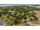 Aerial view of the property's location in a tranquil, tree-filled neighborhood with lake access at 11024 Windchime Cir, Clermont, FL 34711