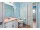 Cozy bathroom with a single sink vanity, toilet, and neutral tile flooring at 11024 Windchime Cir, Clermont, FL 34711