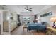 Comfortable bedroom featuring wood floors, a ceiling fan, backyard access, and ample natural light at 11024 Windchime Cir, Clermont, FL 34711