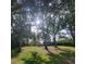 Expansive community green space featuring mature trees, pavilion, and lush landscaping, perfect for outdoor enjoyment at 11024 Windchime Cir, Clermont, FL 34711