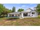 Back of house featuring a trampoline, a covered patio and view to a well-maintained yard at 11024 Windchime Cir, Clermont, FL 34711