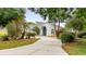 Charming single-story home featuring a well-manicured lawn and a curved driveway leading to the front entrance at 11024 Windchime Cir, Clermont, FL 34711
