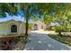 Charming single-story home with a well-maintained lawn, mature trees, and a long driveway at 11024 Windchime Cir, Clermont, FL 34711