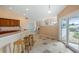 Eat-in kitchen features bar seating, tile floors, and easy access to the outdoor area at 11024 Windchime Cir, Clermont, FL 34711