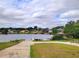 Picturesque lake view with boat ramp, lush green landscape, and charming lakeside homes at 11024 Windchime Cir, Clermont, FL 34711