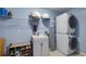 Efficient laundry room with a stacked washer and dryer and ample storage at 11024 Windchime Cir, Clermont, FL 34711