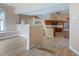 Open-concept living area flowing into the kitchen, featuring tile floors and bright lighting at 11024 Windchime Cir, Clermont, FL 34711