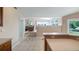View from the kitchen into the sun-filled living room, showcasing the open floor plan and neutral tones at 11024 Windchime Cir, Clermont, FL 34711