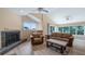 Inviting living room with a fireplace, vaulted ceilings, and comfortable seating arrangement at 11024 Windchime Cir, Clermont, FL 34711