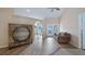 Cozy living room featuring wood floors, neutral paint, ceiling fan and an archway leading to the foyer at 11024 Windchime Cir, Clermont, FL 34711