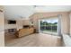 Open living area featuring a fireplace, high ceilings, and a sliding glass door to the backyard at 11024 Windchime Cir, Clermont, FL 34711