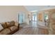 Open-concept living area with tile flooring, seamlessly connecting the dining area and front entryway at 11024 Windchime Cir, Clermont, FL 34711