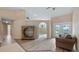 Cozy living room showcasing open layout, hardwood floors, and access to backyard at 11024 Windchime Cir, Clermont, FL 34711