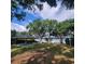 Community pavilion with picnic tables and seating areas surrounded by mature trees and a view of the lake at 11024 Windchime Cir, Clermont, FL 34711