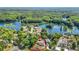 Stunning aerial view of home with lush greenery and beautiful lake views in a desirable neighborhood at 12110 Palmetto Ct, Dunnellon, FL 34432