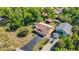 Aerial view of property showing home, long driveway, boat lift, and mature trees at 12110 Palmetto Ct, Dunnellon, FL 34432
