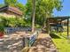 Beautiful backyard combining a brick patio, fire pit, and covered boat lift for waterfront access at 12110 Palmetto Ct, Dunnellon, FL 34432