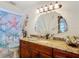 Bathroom featuring a granite countertop, shell mirror, and a starfish shower curtain at 12110 Palmetto Ct, Dunnellon, FL 34432