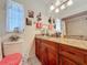 Bathroom featuring granite countertops, wood cabinets, decorated mirror, and walk-in shower at 12110 Palmetto Ct, Dunnellon, FL 34432