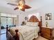 Bedroom featuring a leaf fan, palm tree bedding, and access to the lanai at 12110 Palmetto Ct, Dunnellon, FL 34432