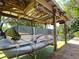 Covered boat lift showing a pontoon boat and wooden dock at 12110 Palmetto Ct, Dunnellon, FL 34432