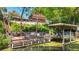 Waterfront dock with a fire pit, seating, and boat lift, creating a scenic outdoor space at 12110 Palmetto Ct, Dunnellon, FL 34432