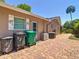 Exterior of home showing custom shutters, brick patio, and backyard at 12110 Palmetto Ct, Dunnellon, FL 34432