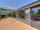 Long sunroom on home's exterior with doors to a wood deck at 12110 Palmetto Ct, Dunnellon, FL 34432