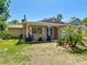 Quaint one-story home featuring mature landscaping, a well-manicured lawn and paved driveway at 12110 Palmetto Ct, Dunnellon, FL 34432
