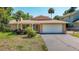 Lovely one-story home featuring a well-manicured lawn, mature landscaping and a paved driveway at 12110 Palmetto Ct, Dunnellon, FL 34432