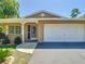 Charming home featuring a well-manicured lawn, neutral paint scheme, and an attached one-car garage at 12110 Palmetto Ct, Dunnellon, FL 34432
