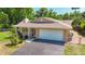 Charming one-story home featuring mature landscaping, well-manicured lawn and a paved driveway at 12110 Palmetto Ct, Dunnellon, FL 34432