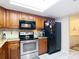 Kitchen has granite countertops and stainless steel appliances and tile flooring and laundry room adjacent at 12110 Palmetto Ct, Dunnellon, FL 34432