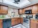 This kitchen features granite countertops, and modern stainless steel appliances, under bright lighting at 12110 Palmetto Ct, Dunnellon, FL 34432