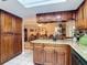 Kitchen view into dining area, with granite countertops, tile flooring, and wood cabinets at 12110 Palmetto Ct, Dunnellon, FL 34432