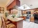 Well-equipped kitchen with wood cabinetry, granite countertops and stainless steel appliances at 12110 Palmetto Ct, Dunnellon, FL 34432