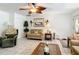 Cozy living room with tile floors, a ceiling fan, and comfortable furniture perfect for relaxing at 12110 Palmetto Ct, Dunnellon, FL 34432