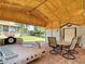 Outdoor structure features trailer, dining set, and shed on a brick patio, open to backyard at 12110 Palmetto Ct, Dunnellon, FL 34432